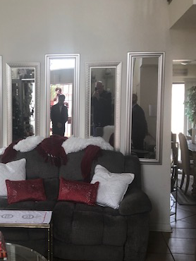 Reflection of Angel and John inspecting the Property in Lancaster CA.